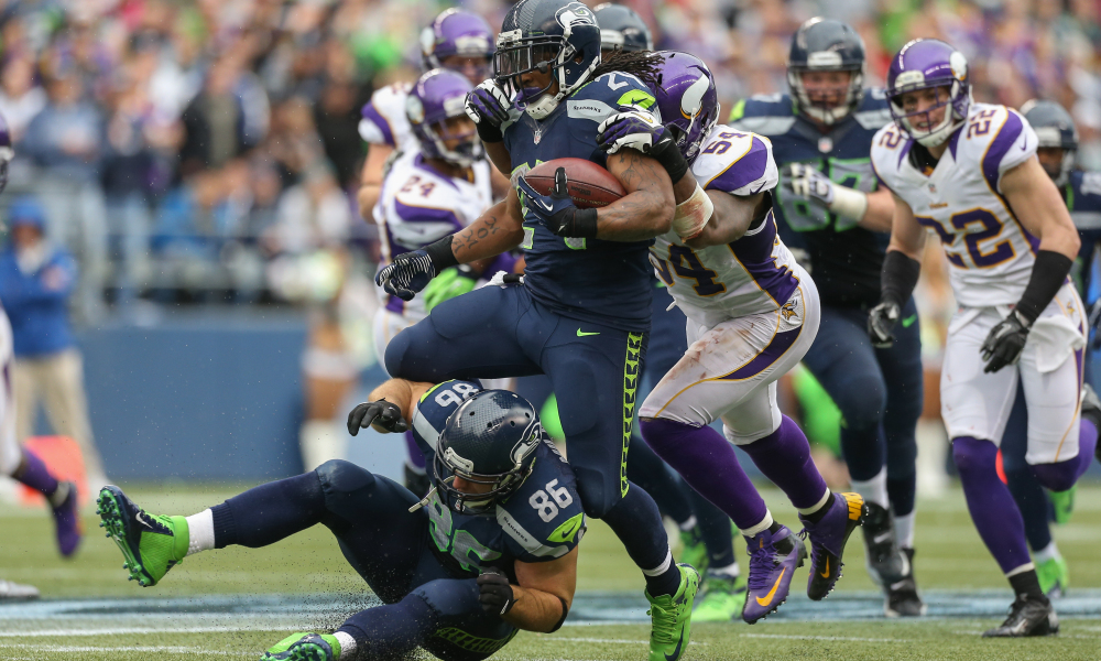 SEATTLE, WA - NOVEMBER 04:  Running back Marshawn Lynch #24 of the Seattle Seahawks rushes over teammate Zach Miller #86 against the Minnesota Vikings at CenturyLink Field on November 4, 2012 in Seattle, Washington. The Seahawks defeated the Vikings 30-20.  (Photo by Otto Greule Jr/Getty Images)
