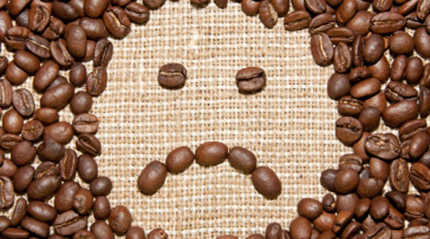 coffee beans sad smile on burlap background