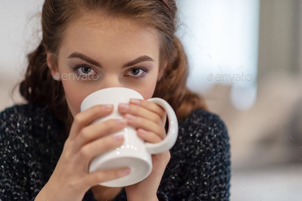 beautiful woman drinking coffee in the morning at home